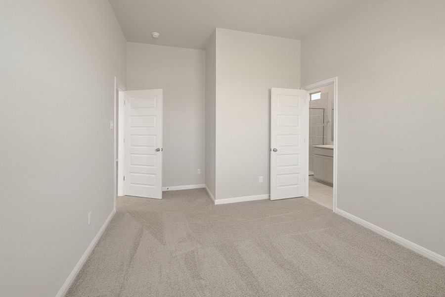 Primary Bedroom in the Ash home plan by Trophy Signature Homes – REPRESENTATIVE PHOTO