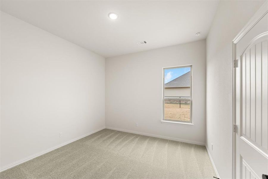 Spare room with light carpet and recessed lighting