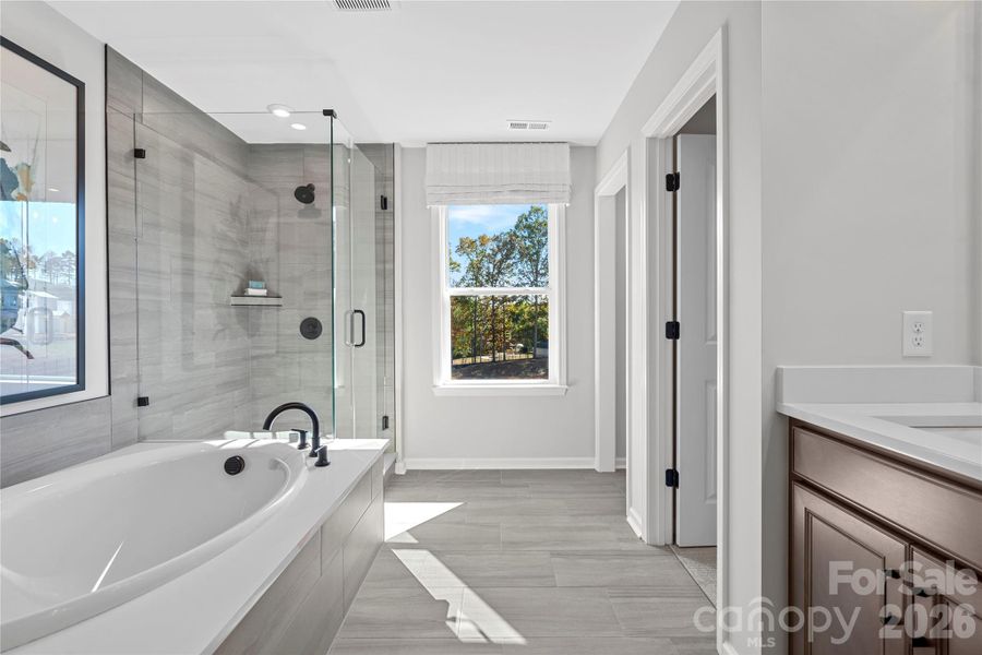 Modern tile and bright window breathes light to the bath. Modern tile and bright window breathes light to the bath.