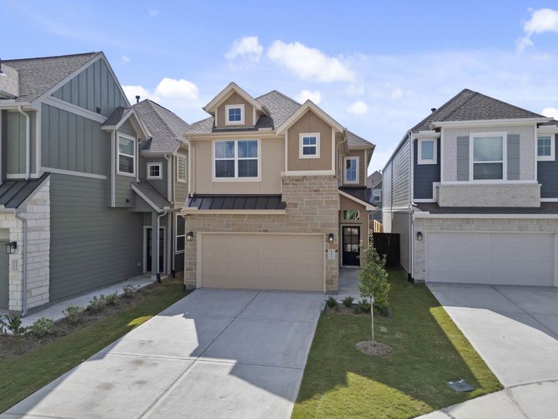 Front exterior of a new home in Meridiana, Manvel, TX, highlighting curb appeal (Image 17).
