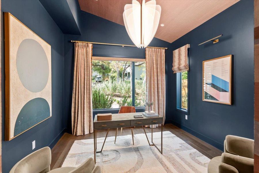 The office or additional flex space wraps guests in deep blue serenity.