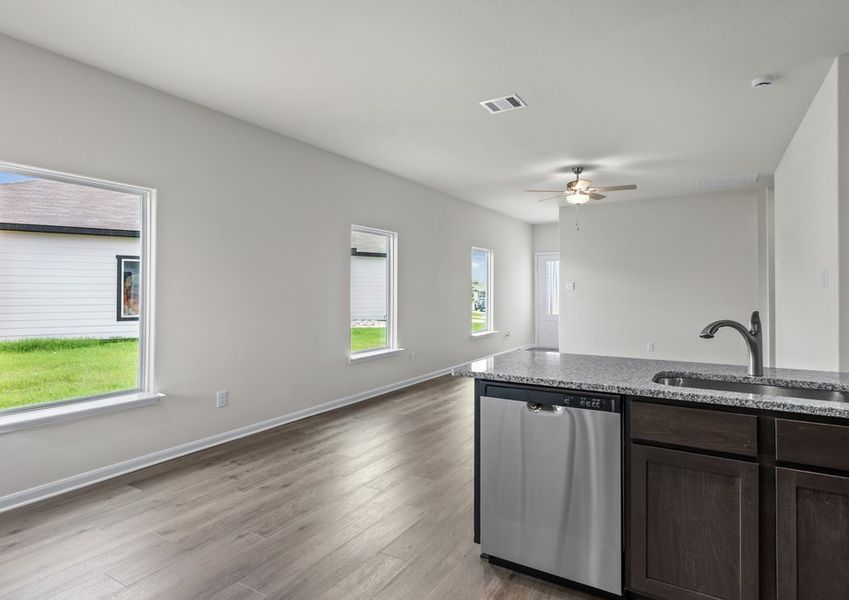 The kitchen looks over into the family room.