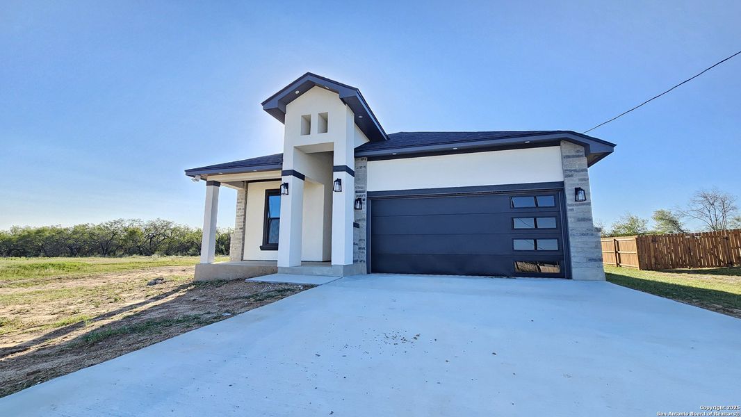 Front exterior of a new home in , Atascosa, TX, highlighting curb appeal (Image 2). Front exterior of a new home in , Atascosa, TX, highlighting curb appeal (Image 2).