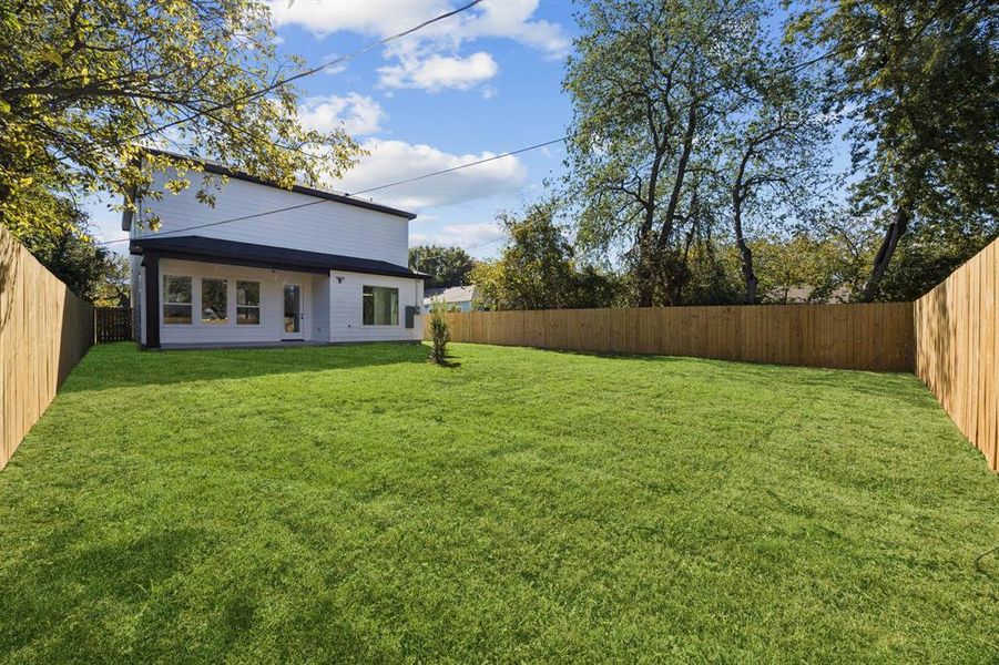 Fenced backyard with a patio area