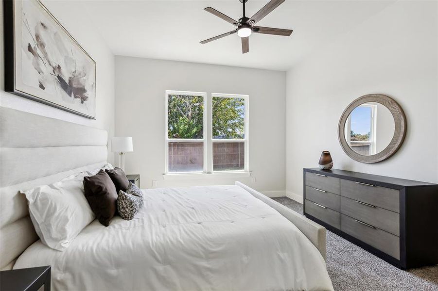 Bedroom featuring ceiling fan and carpet