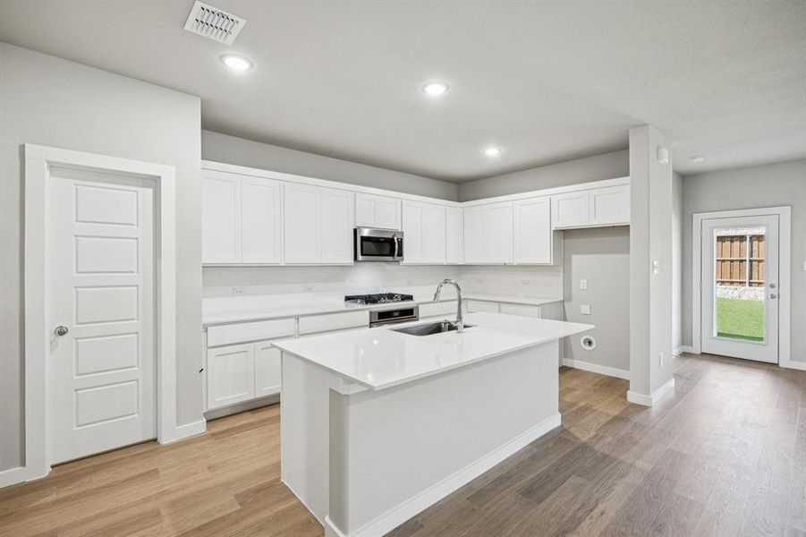 Kitchen in the Oscar home plan by Trophy Signature Homes – REPRESENTATIVE PHOTO Kitchen in the Oscar home plan by Trophy Signature Homes – REPRESENTATIVE PHOTO