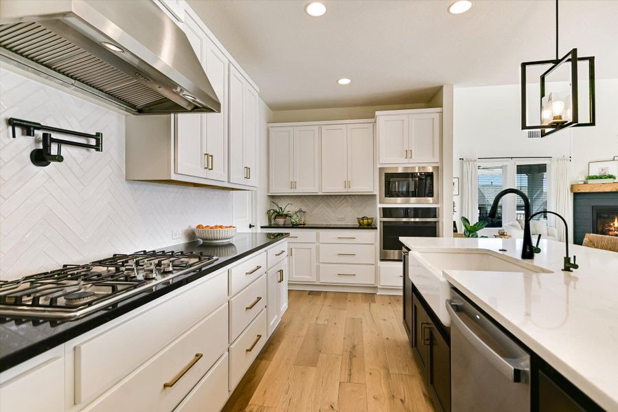 This spacious two-tone kitchen with stainless steel appliances, an apron front sink and a custom kitchen island will keep the Family Chef happy and content for years to come.