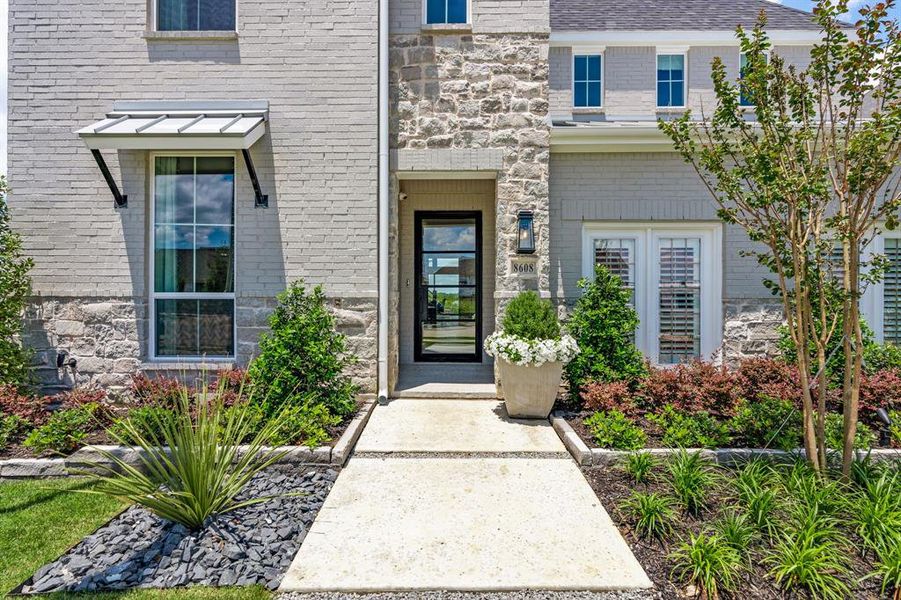Property entrance featuring stone siding and brick siding Property entrance featuring stone siding and brick siding