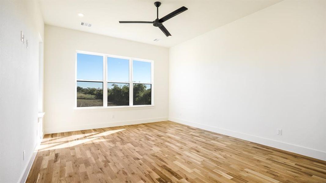 Spare room with ceiling fan and light hardwood / wood-style flooring