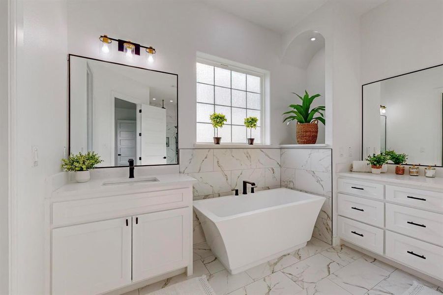 Main Bathroom with tile patterned flooring, a bath, and vanity