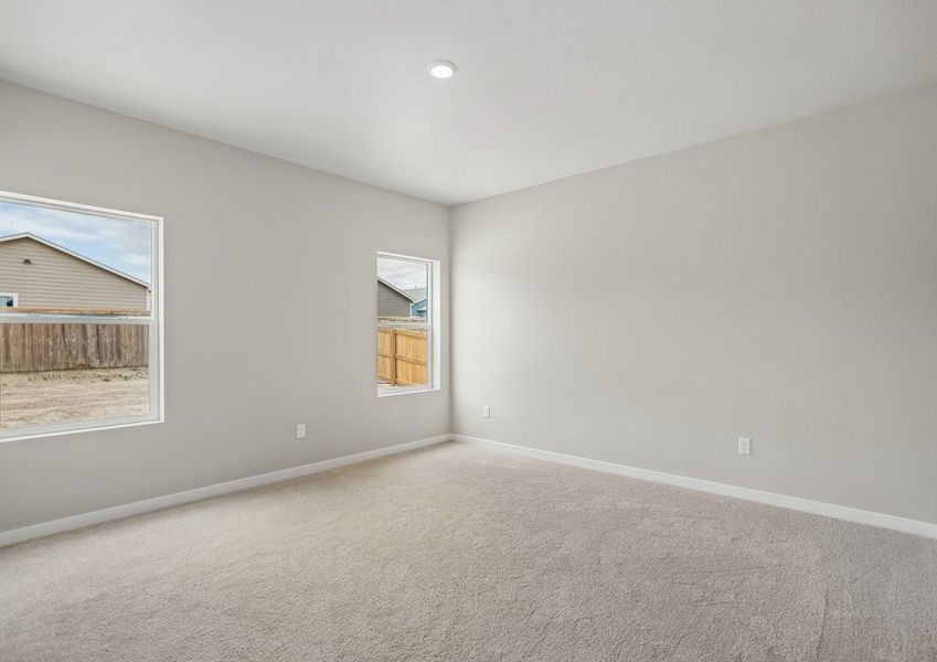 The master bedroom is spacious with large windows.