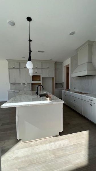 Upgraded kitchen hood and scone lighting for added light and mood. Pendant lights shine just the right light.