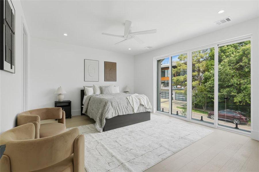 Expansive room featuring light wood-finish flooring and a white ceiling with recessed lighting