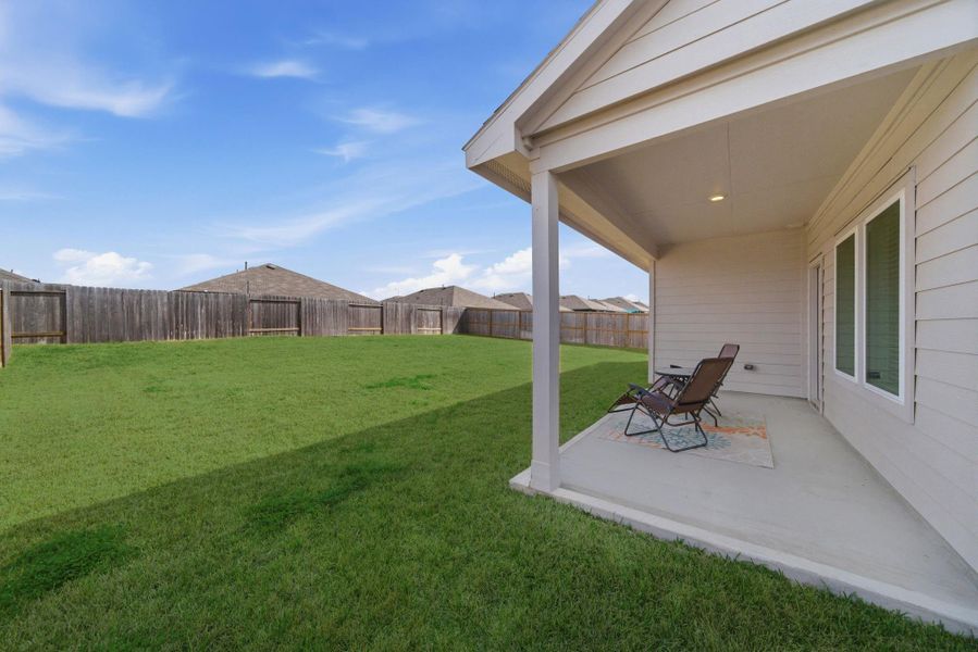 Covered patio overlooking a larger backyard with room to customize, entertain, and play.