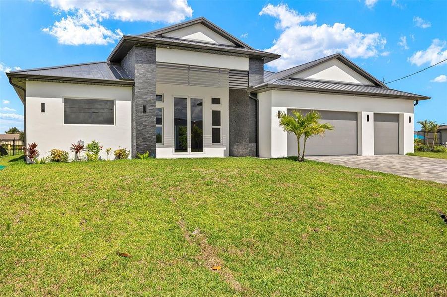 Front exterior of a new home in , Cape Coral, FL, highlighting curb appeal (Image 29). Front exterior of a new home in , Cape Coral, FL, highlighting curb appeal (Image 29).