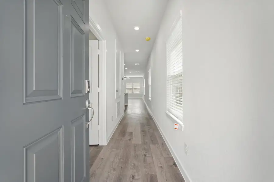 A hallway with white doors. A hallway with white doors.