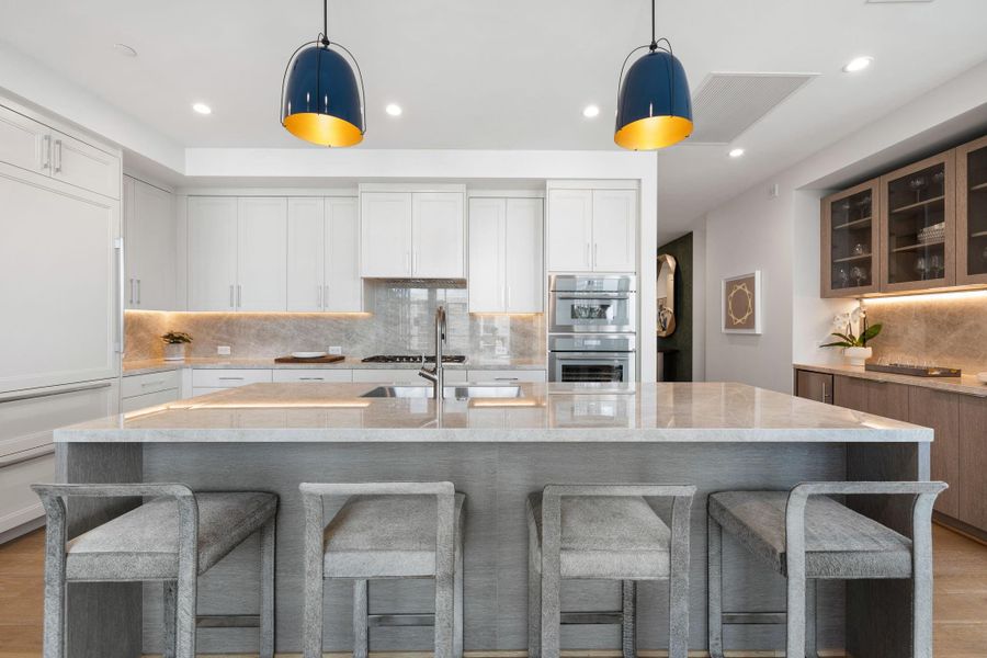 Oversized center island with porcelain counter-top and pull-out seating. Photos are of a similar unit with the same floor plan