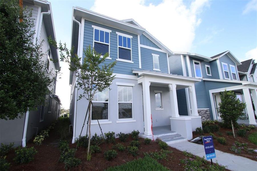 Front exterior of a new home in Laureate Park at Lake Nona - Garden Series, Orlando, FL, highlighting curb appeal (Image 2). Front exterior of a new home in Laureate Park at Lake Nona - Garden Series, Orlando, FL, highlighting curb appeal (Image 2).