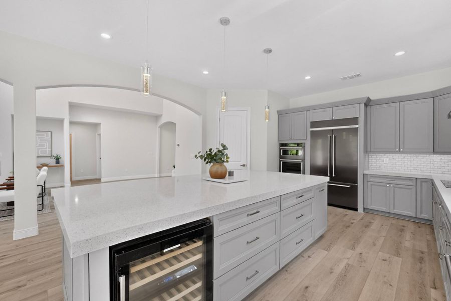 Clean lines and stone countertops anchor this modern kitchen with premium integrated appliances.