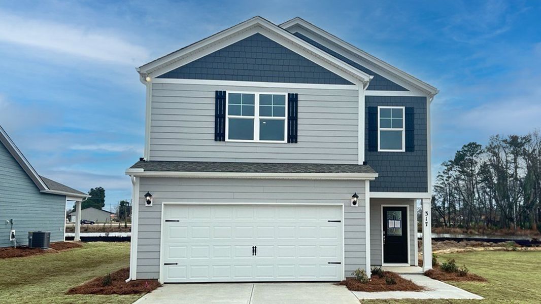 Front exterior of a new home in Sease's Pond, Gilbert, SC, highlighting curb appeal (Image 1).