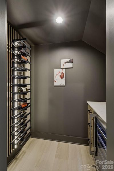 One of the best hidden gems of this home is this wine cellar! No detail has been missed with the lighted wine bottle fixture, the wine refrigerator, and cabinetry. One of the best hidden gems of this home is this wine cellar! No detail has been missed with the lighted wine bottle fixture, the wine refrigerator, and cabinetry.