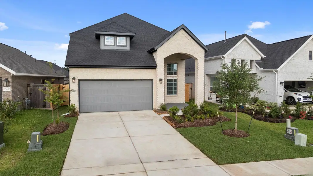 Front exterior of a new home in Emory Glen, Magnolia, TX, highlighting curb appeal (Image 20).