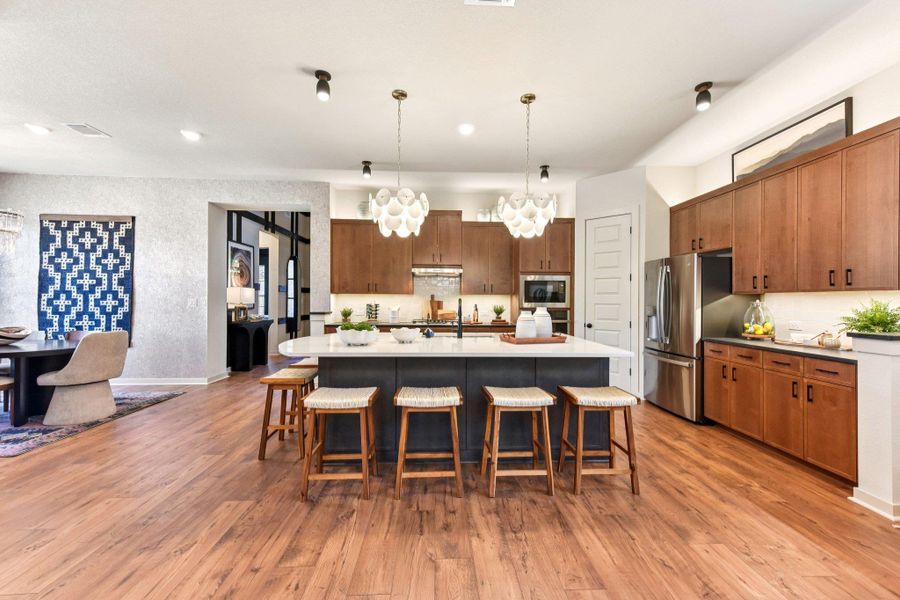 An inviting open-concept kitchen features a spacious island and rich wood flooring, perfect for entertaining. An inviting open-concept kitchen features a spacious island and rich wood flooring, perfect for entertaining.