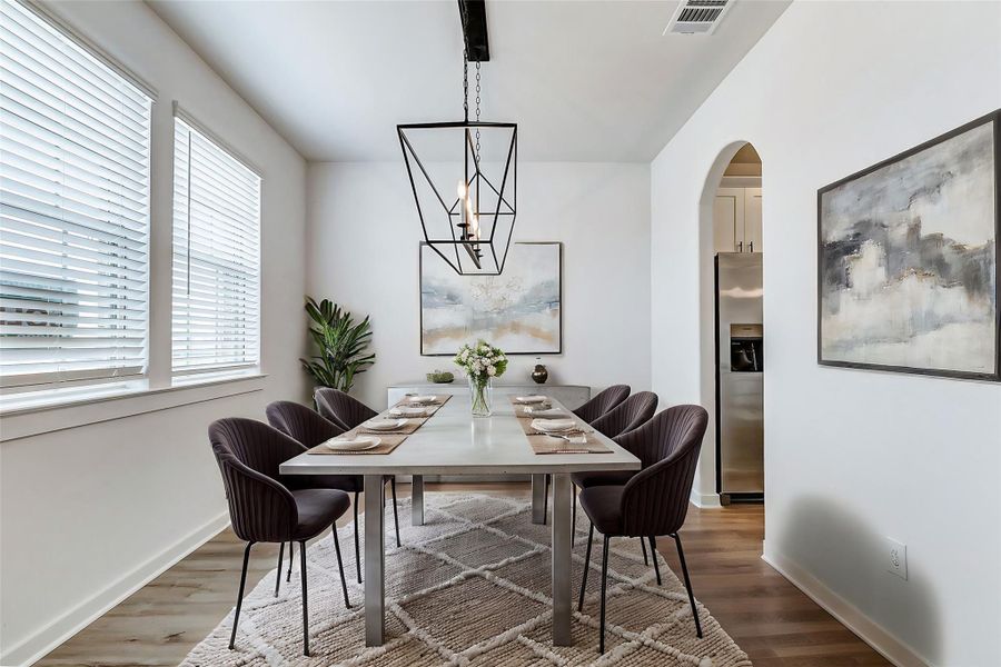 Bright and inviting, the dining area features large windows that let in abundant natural light. The modern chandelier adds a touch of elegance, making it the perfect space for intimate dinners or festive gatherings. **This is a picture of a Rylan Floor Plan from another Saratoga Homes.** Bright and inviting, the dining area features large windows that let in abundant natural light. The modern chandelier adds a touch of elegance, making it the perfect space for intimate dinners or festive gatherings. **This is a picture of a Rylan Floor Plan from another Saratoga Homes.**
