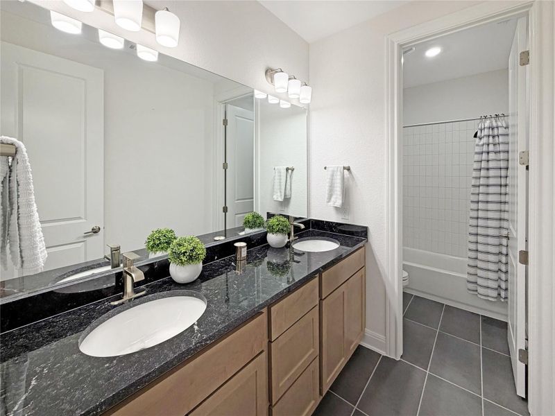 Full bathroom shared between bedroom 3 and 4, primary floor