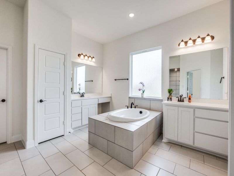 Bathroom with a garden tub, a sink, tile patterned flooring, and two vanities Bathroom with a garden tub, a sink, tile patterned flooring, and two vanities