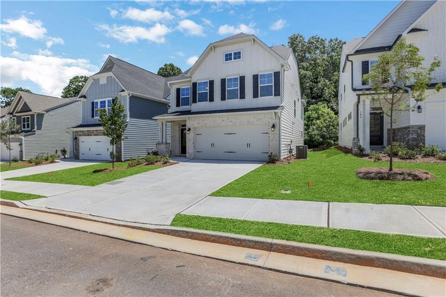 Front exterior of a new home in Villas at Dawsonville, Dawsonville, GA, highlighting curb appeal (Image 21). Front exterior of a new home in Villas at Dawsonville, Dawsonville, GA, highlighting curb appeal (Image 21).