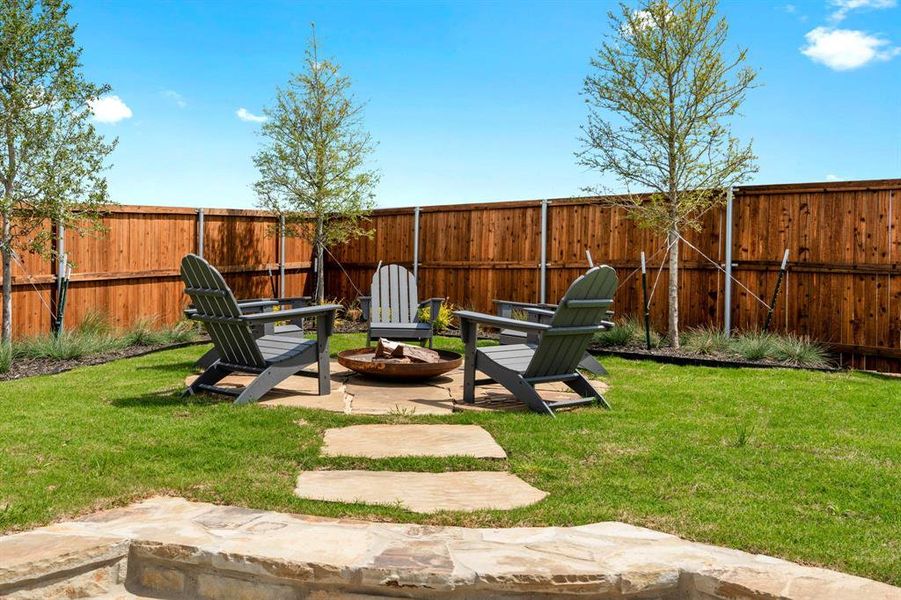 View of yard with an outdoor fire pit and a patio