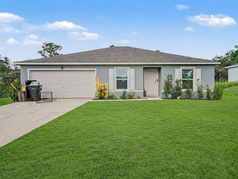 Front exterior of a new home in Poinciana, Poinciana, FL, highlighting curb appeal (Image 1). Front exterior of a new home in Poinciana, Poinciana, FL, highlighting curb appeal (Image 1).