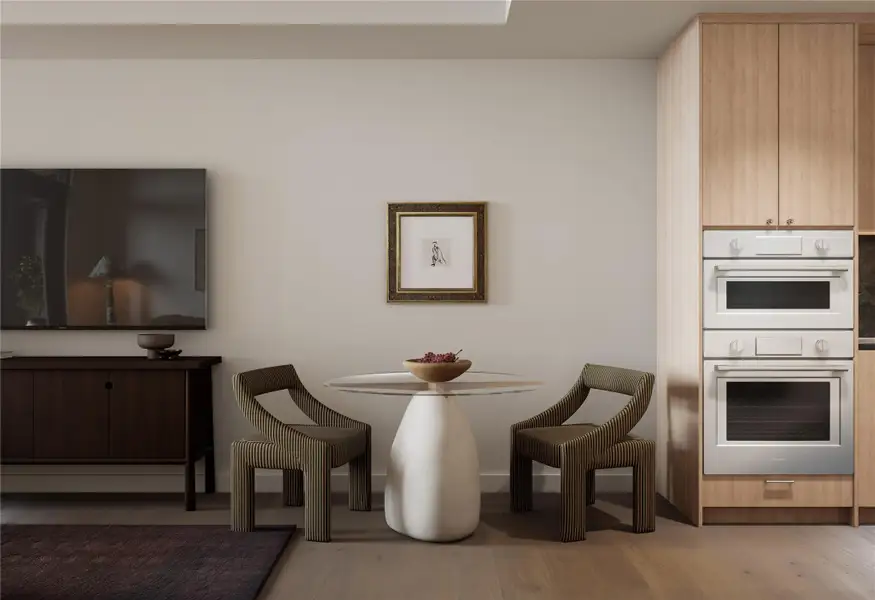 Open dining area with wood floors and skyline view.