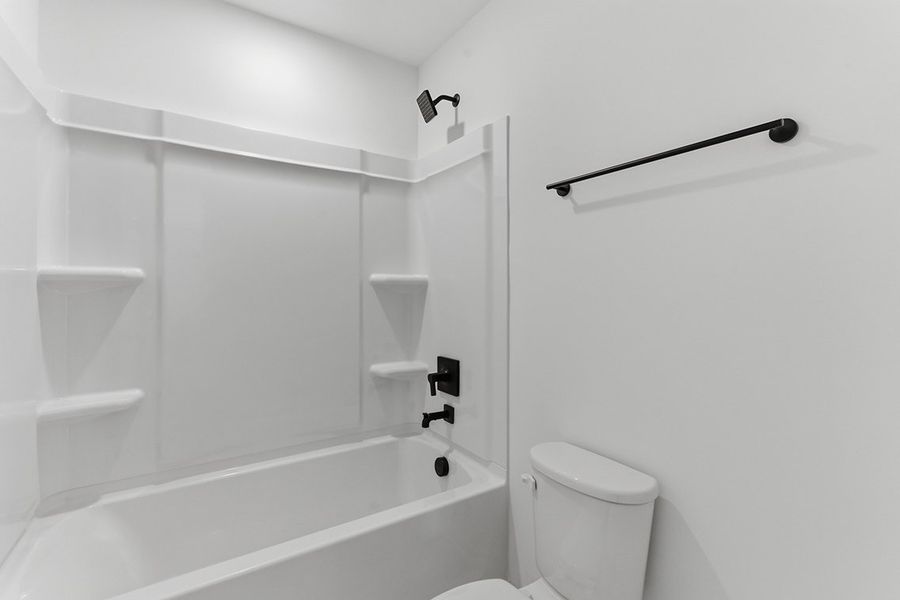 A bathroom with a bathtub toilet and sink.