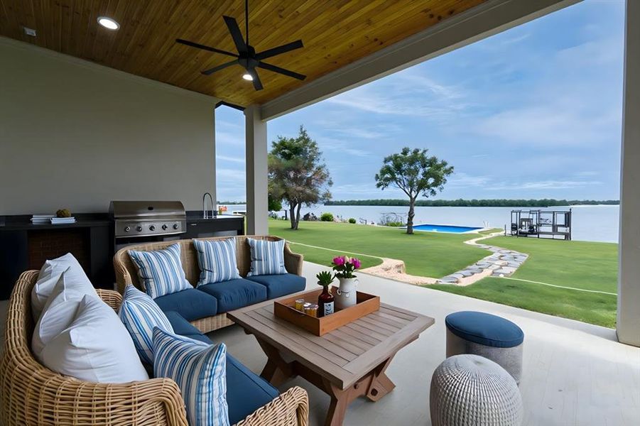 Virtually Staged View of First Floor patio / terrace featuring an outdoor kitchen, a grill, a water view, outdoor lounge area, and ceiling fan Virtually Staged View of First Floor patio / terrace featuring an outdoor kitchen, a grill, a water view, outdoor lounge area, and ceiling fan