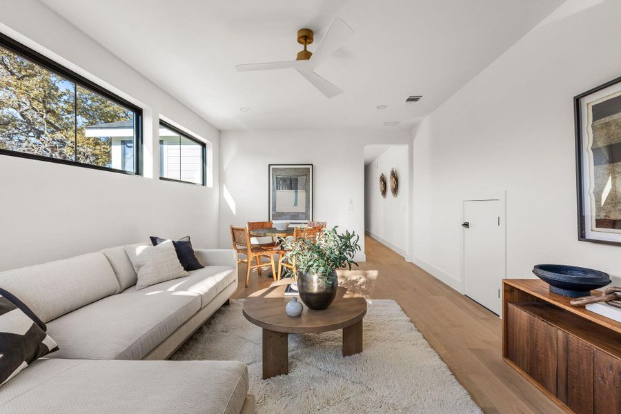 Living room with wood finished floors and a ceiling fan
