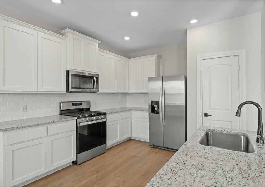 The upgraded kitchen has beautiful white wood cabinetry. The upgraded kitchen has beautiful white wood cabinetry.