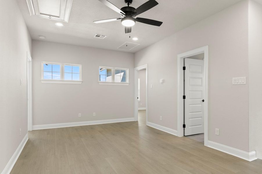 Unfurnished room with attic access, light wood finished floors, a ceiling fan, and recessed lighting Unfurnished room with attic access, light wood finished floors, a ceiling fan, and recessed lighting