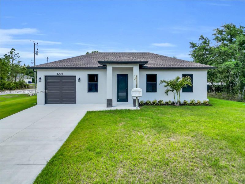 Front exterior of a new home in , Lehigh Acres, FL, highlighting curb appeal (Image 25).
