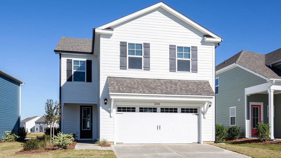 Front exterior of a new home in Indigo Preserve, Leland, NC, highlighting curb appeal (Image 1).