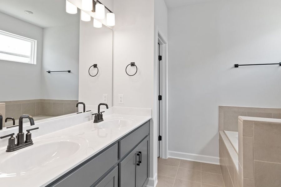 A bathroom with a sink and a bathtub. A bathroom with a sink and a bathtub.