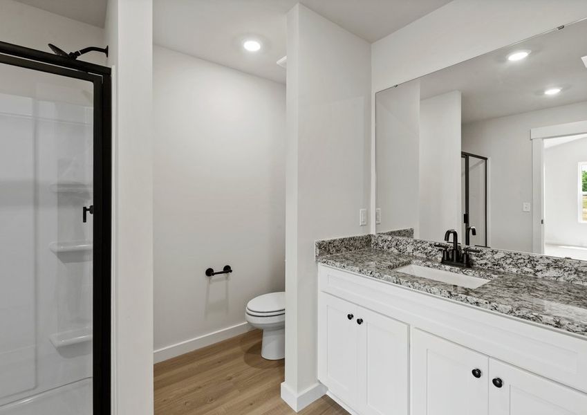 The master bathroom has a glass-enclosed shower