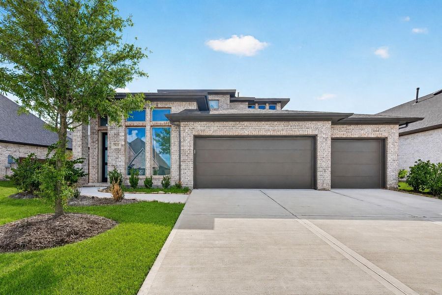 Front exterior of a new home in Cane Island, Katy, TX, highlighting curb appeal (Image 25).