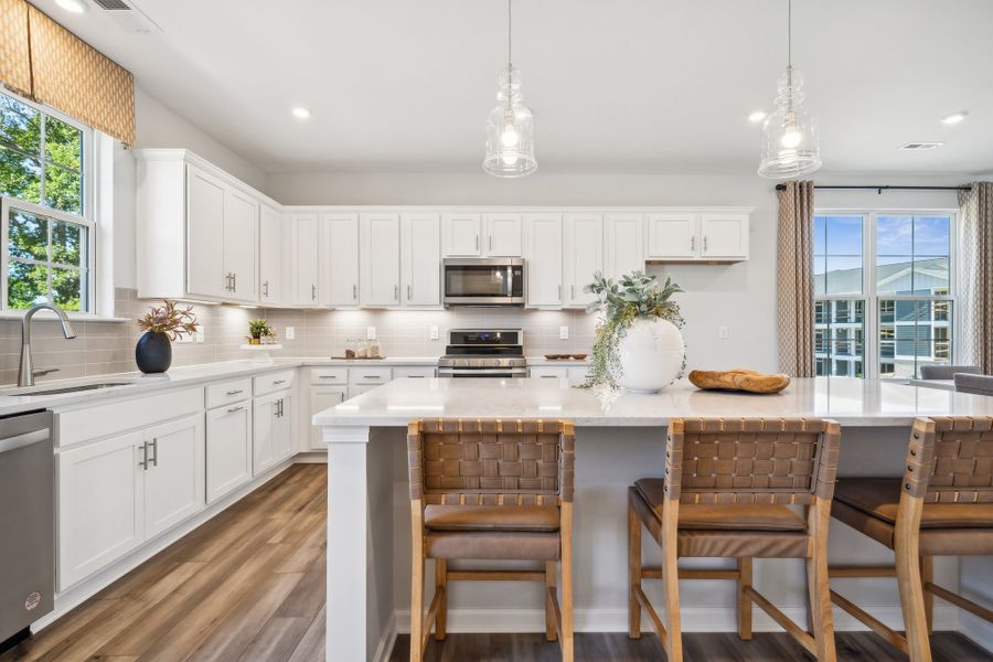 A kitchen with a table and chairs.