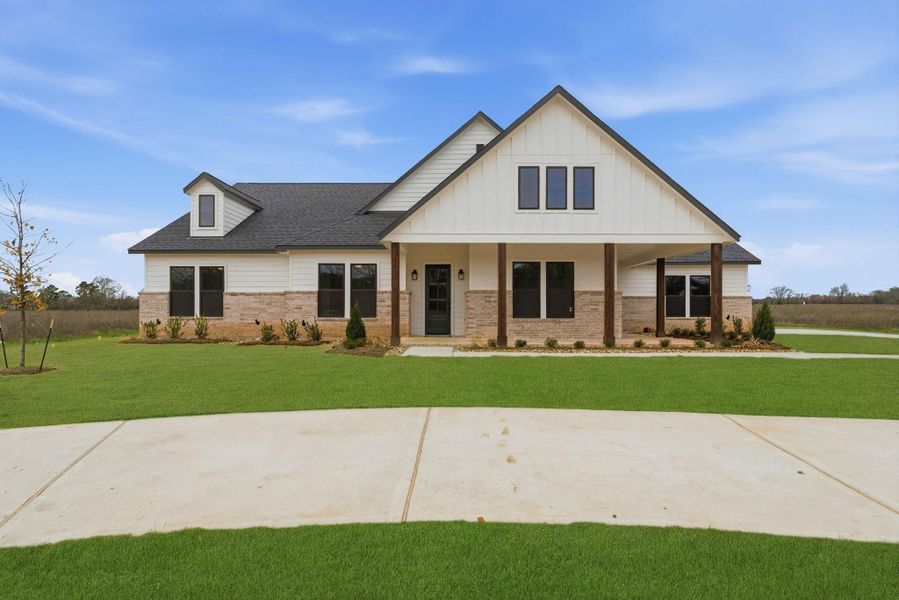 Front exterior of a new home in High Meadow Estates, New Waverly, TX, highlighting curb appeal (Image 29).