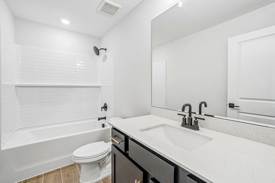 First is the 2nd bathroom located off the main hallway near the secondary bedrooms this bathroom features aspects of AW Collection® Noir First is the 2nd bathroom located off the main hallway near the secondary bedrooms this bathroom features aspects of AW Collection® Noir