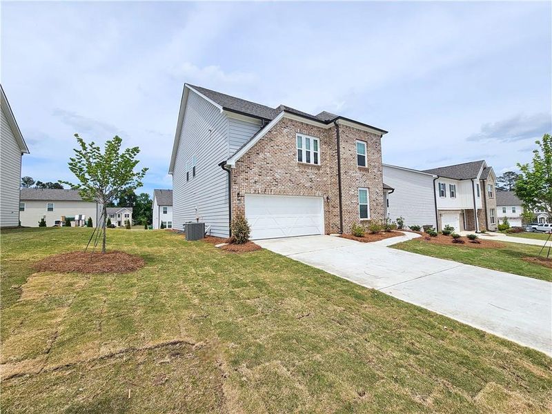 Front exterior of a new home in The Estates at Casteel, Bethlehem, GA, highlighting curb appeal (Image 2). Front exterior of a new home in The Estates at Casteel, Bethlehem, GA, highlighting curb appeal (Image 2).