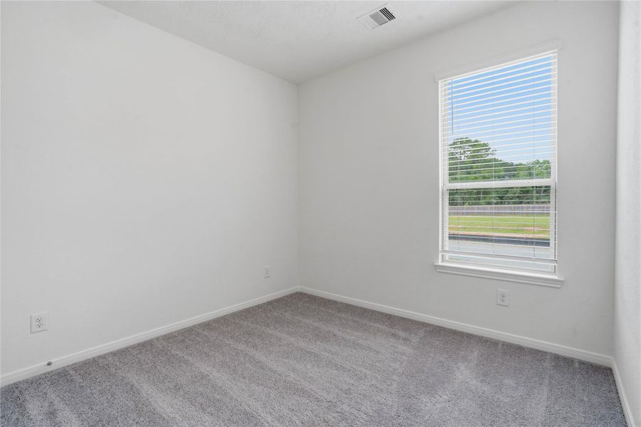 This secondary bedroom offers comfort and style with plush carpeting, neutral paint tones, recessed lighting, a large window with blinds, and a generously sized closet. This secondary bedroom offers comfort and style with plush carpeting, neutral paint tones, recessed lighting, a large window with blinds, and a generously sized closet.