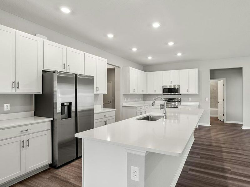 Your luxurious kitchen features quartz, 42-inch cabinets, Samsung SS appliances, and a walk-in pantry.